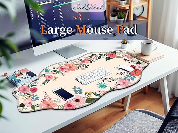 Large floral mouse pad on a white desk with keyboard and phone, creating a cozy workspace decor.