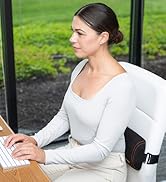 Woman typing in an office with the McKenzie Signature Slimline Lumbar Roll attached to office chair