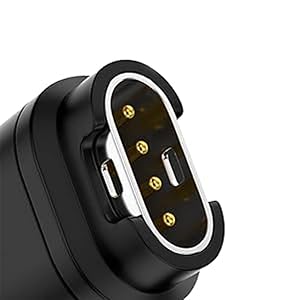 Close-up of black electronic connector with oval-shaped metal rim and four gold contact pins visible inside.