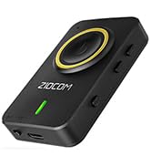 Small black electronic device with circular yellow accent. Features a green LED indicator and appears to have USB ports.