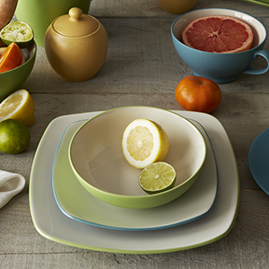 Colorwave Apple and Turquoise dinnerware, mixed on a dining table.