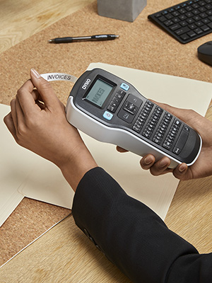 person typing the Dymo LM160 model