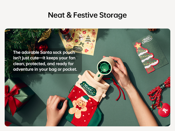 Text reads 'Neat &amp; Festive Storage' and 'The adorable Santa sock pouch isn't just cute—it keeps your fun clean, protected, and ready for adventure in your bag or pocket.' Hands arranging Christmas-themed items on green surface.