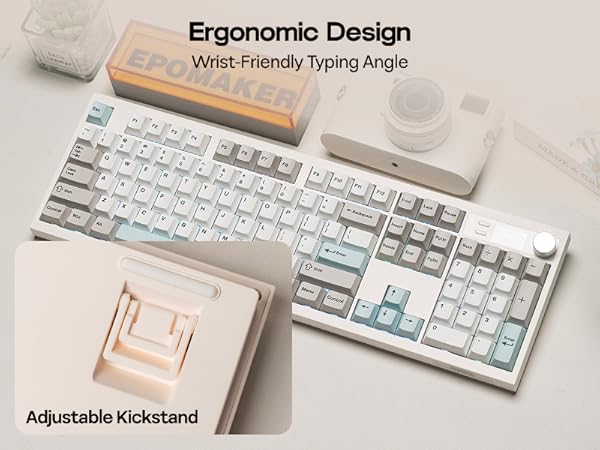 Text reads 'Ergonomic Design' and 'Wrist-Friendly Typing Angle' and 'Adjustable Kickstand'. White mechanical keyboard shown from multiple angles demonstrating adjustable height features.
