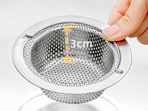 Stainless steel sink strainer being demonstrated, showing installation process in drain. Features perforated mesh design for catching debris.