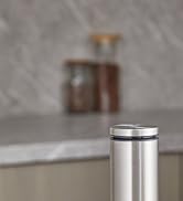 Stainless steel cylindrical container with lid, possibly for spices or seasoning. Sleek modern design with smooth metallic finish.