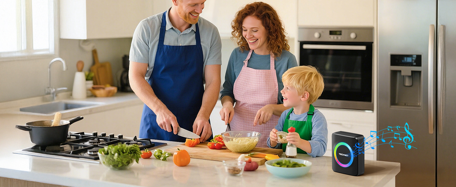 Similar kitchen scene from different angle showing family cooking together, with smart speaker visible on counter and various ingredients spread out.