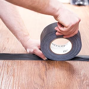 a pro gaffer using gaffer tape on set from gaffer power