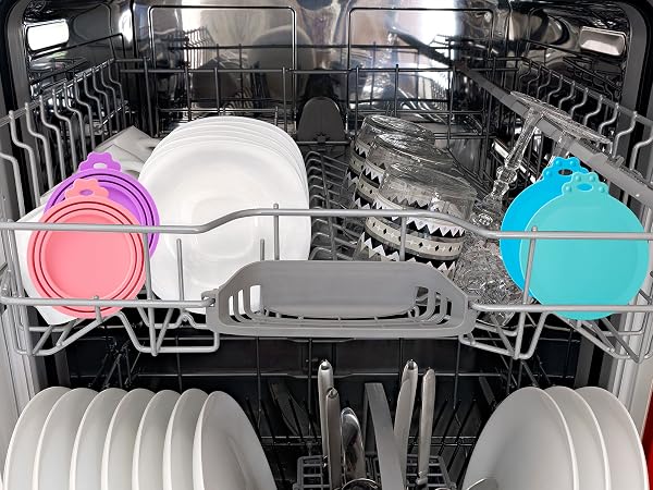 Interior view of a dishwasher with plates, utensils, and dishes arranged on racks, highlighted with pink and blue overlay markers showing loading zones.