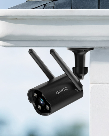 Black outdoor security camera with dual antennas, mounted under an overhang. Features multiple visible lenses and 'GNCC' branding on its cylindrical body.