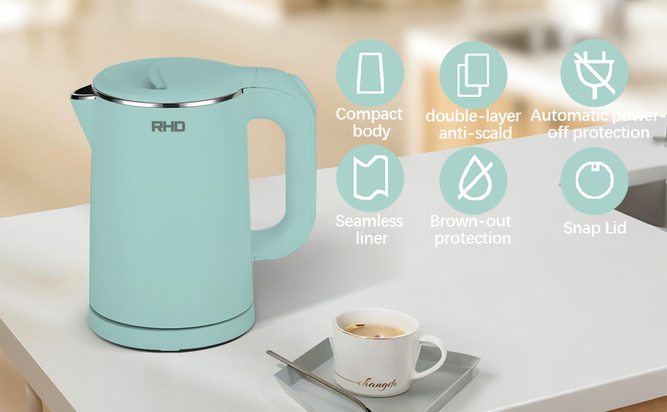 Mint green electric kettle with stainless steel lid, displayed on countertop. Features compact body, anti-scald protection, seamless liner, boil-dry protection, and auto shut-off. Coffee cup visible nearby.
