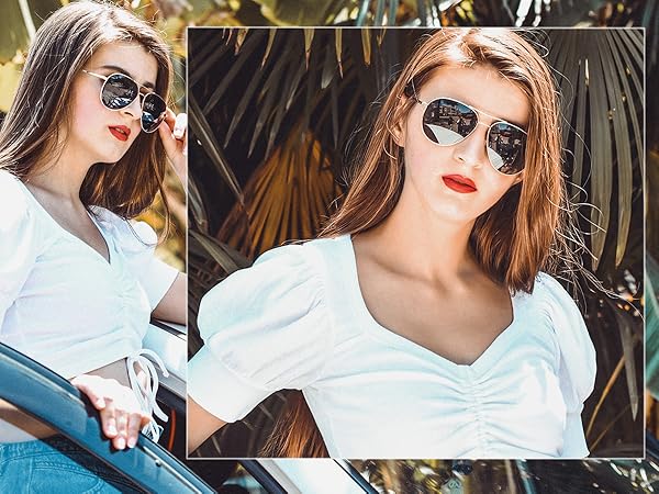 A stylish and elegant lady wearing grey black sunglasses