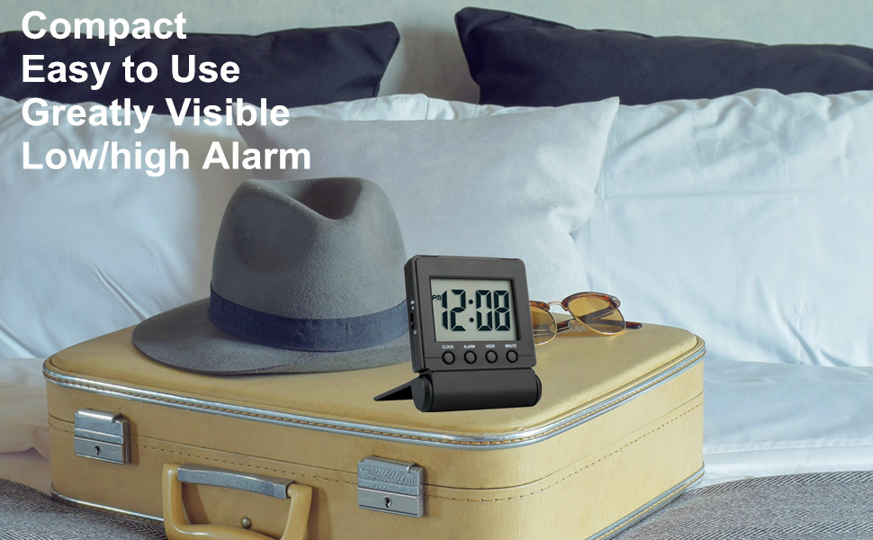 folding travel alarm clock on table