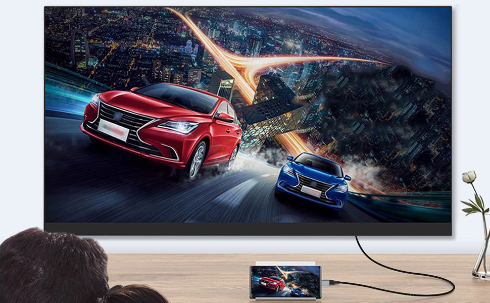 two cars racing on a tv screen with a city skyline in the background.