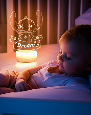 LED night light with cartoon character design casting warm illumination, featuring acrylic panel with engraved 'Dream' text and decorative pattern.