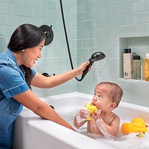 Image of a mother washing her baby with a handheld shower