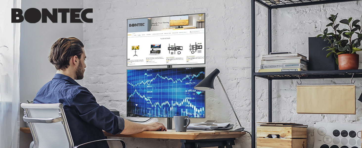 Dual monitor setup displaying financial charts and data on desk, with Bontec branding visible in industrial-style office space.