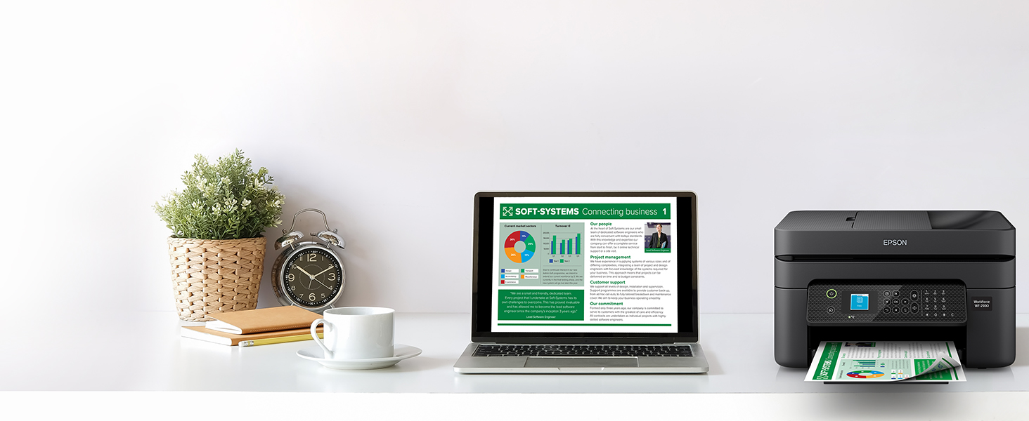 Black WorkForce WF-2930 on desk wirelessly printing content from laptop