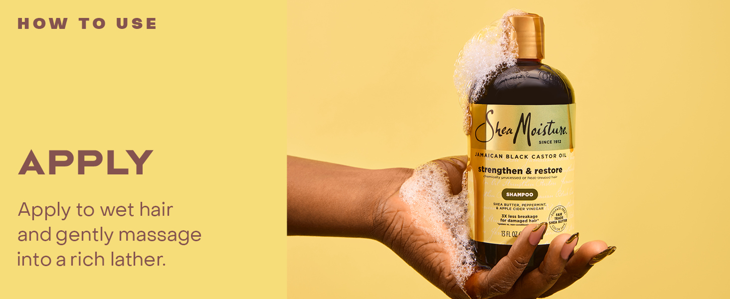 Image of hands holding a shampoo bottle with product.