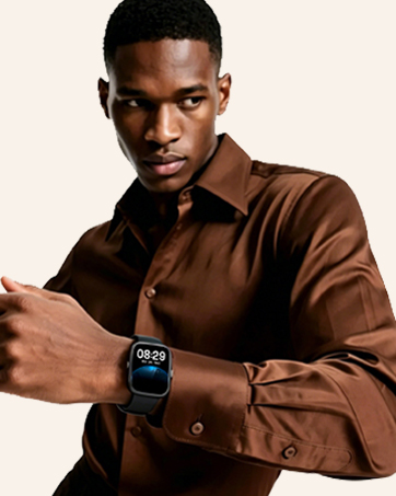 Man wearing brown jacket with smartwatch on wrist, smiling at camera against light background.