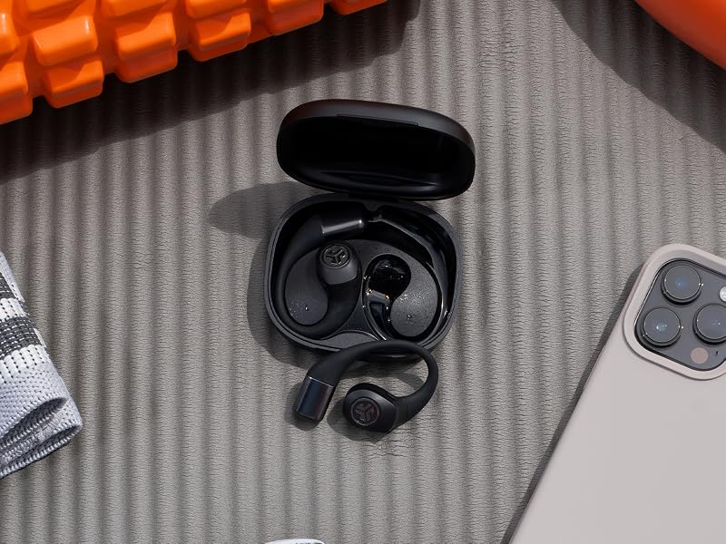 Using the IP55 waterproof earbuds at the gym, placed on the gym mat surrounded by gym essentials