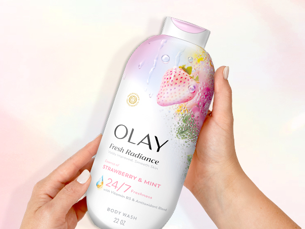 Olay Fresh Radiance Strawberry &amp;amp; Mint in front of a pink background