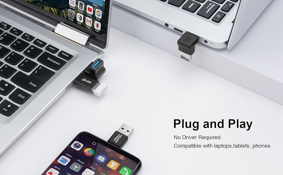 USB adapters connected to laptops and smartphones, demonstrating plug-and-play functionality. Text states 'No Driver Required' and 'Compatible with laptops/tablets/phones'.