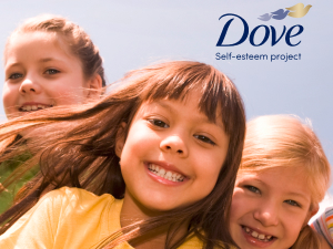 Picture of three young girls smiling against light blue gradient background. 