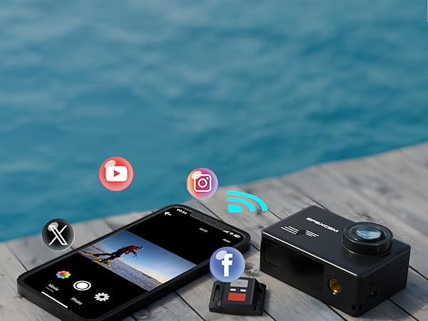 Action camera and smartphone on wooden surface near water. Devices display social media icons. Camera has prominent lens, smartphone shows image capture interface.