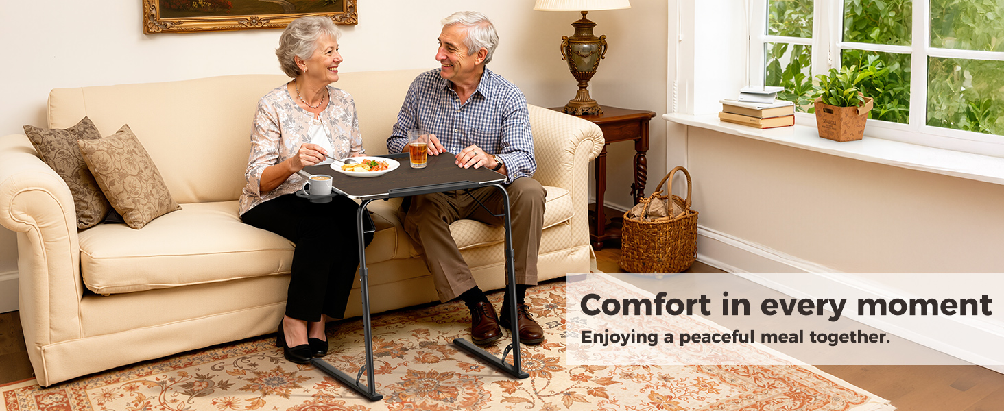 Couple eating on a portable folding dinner table used as a living room TV tray table.
