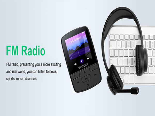 Portable FM radio device with small screen displaying mountain scenery, next to wireless headphones and computer keyboard on light background.