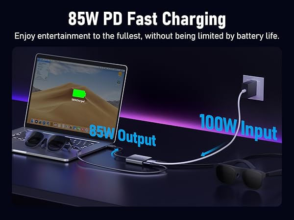 Text reads '85W PD Fast Charging' and 'Enjoy entertainment to the fullest, without being limited by battery life.' Laptop charging setup showing power delivery indicator with blue glow.