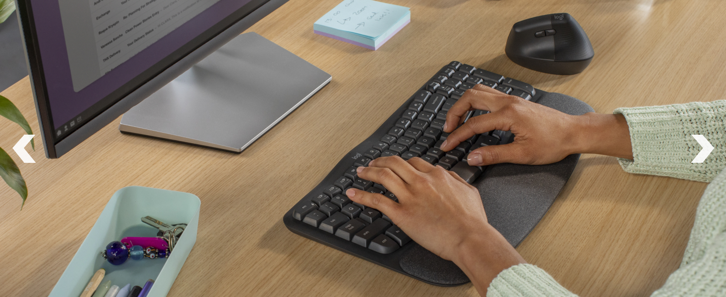 a woman typing on wave keys wireless ergonomic keyboard with a cushioned palm rest
