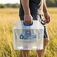 Man holding the collapsible water bag in a field