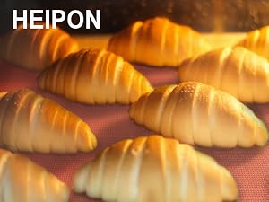 Perforated baking mats for fast and even heat and steam transfer during the baking process