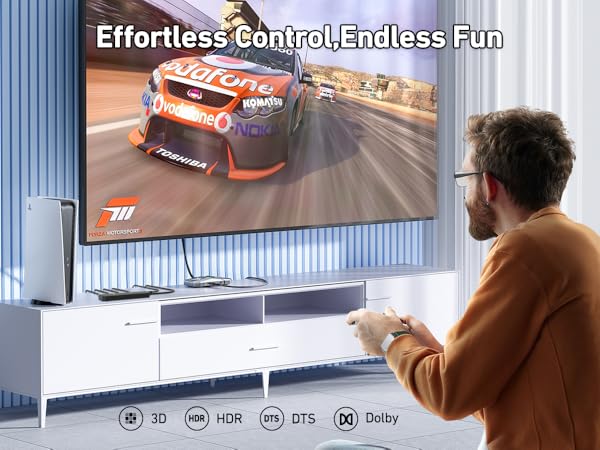 Large wall-mounted display showing racing game interface with 'Effortless Control Endless Fun' text overlay and gaming system icons below.