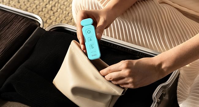 a woman holding a blue remote control in her hand.