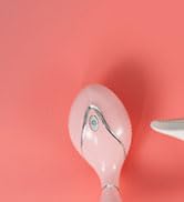 White ballpoint pen against a salmon pink background, showing minimal design and clean lines.