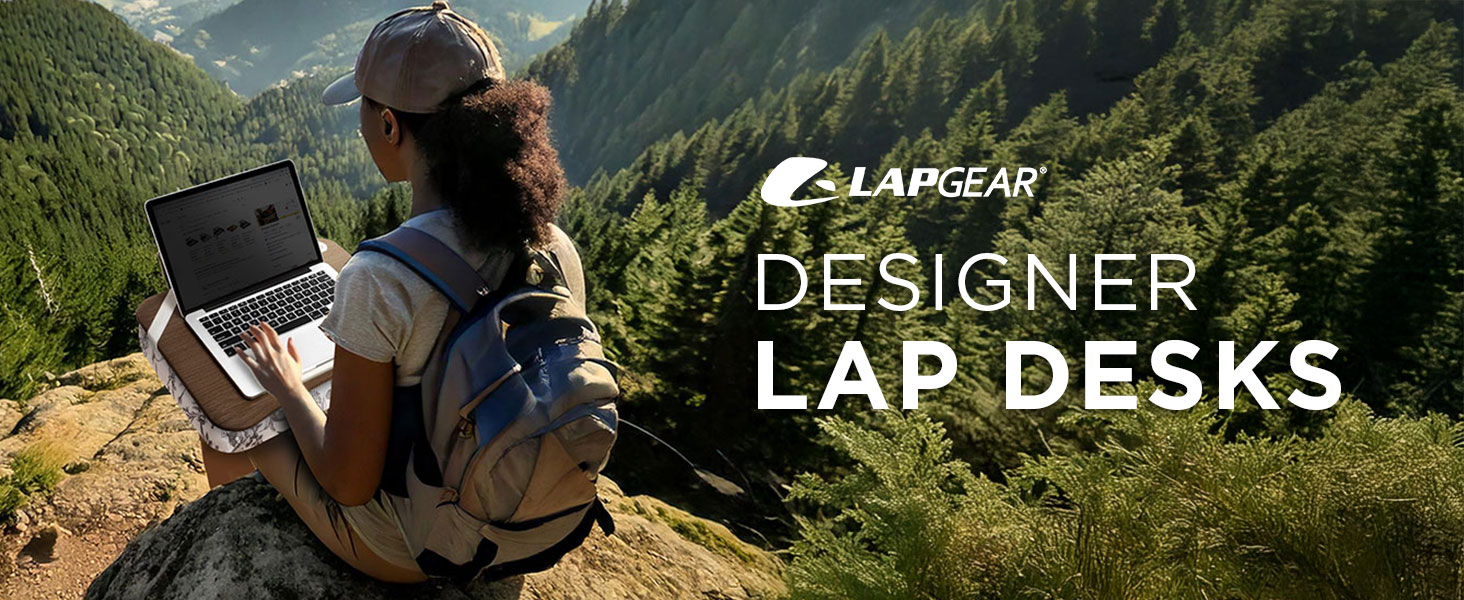 a person using a designer lap desks while working on a laptop at the top of a mountain.