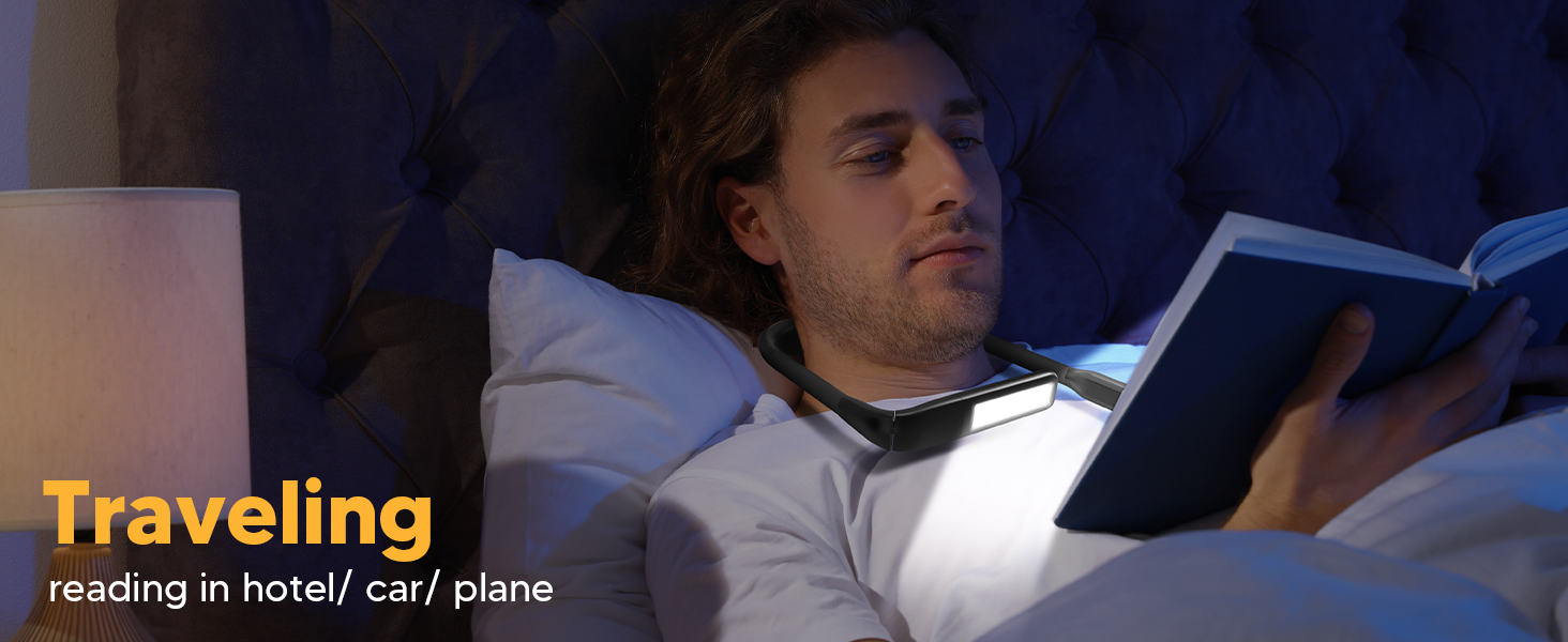 A young man is enjoying reading book in bed in the hotel room with the EastPin LED neck book light