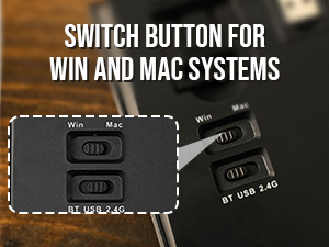 Close-up of a black electronic switch button device labeled for WIN and MAC systems, shown on wooden surface.