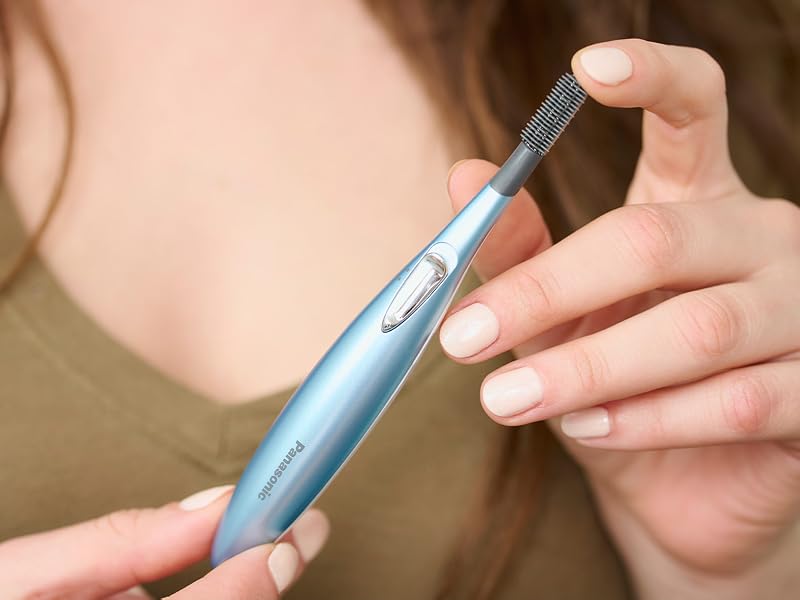Woman holding eyelash curler.