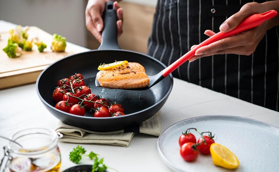 Cooking Spatula removing salmon from a frying pan for plating