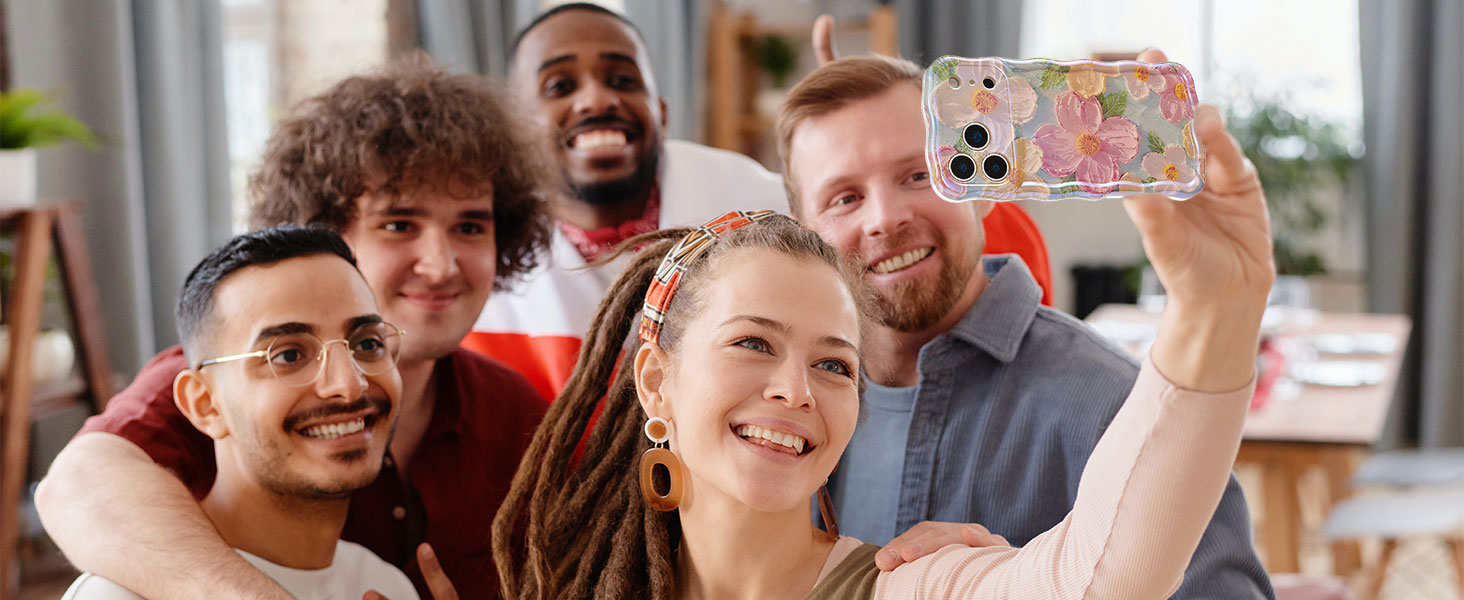 Group of people in casual setting holding up mobile phones while smiling, appearing engaged in a shared activity.