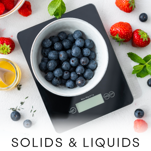 Scale weighing out a bowl of blueberries for baking prep