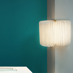 a lamp in a room with a blue wall.