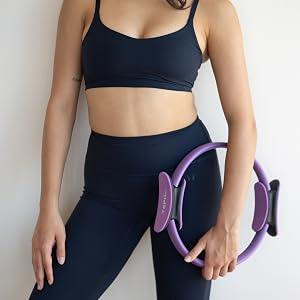 Woman holding YOPIL purple Pilates ring for inner thighs, glutes, core, and Pilates training