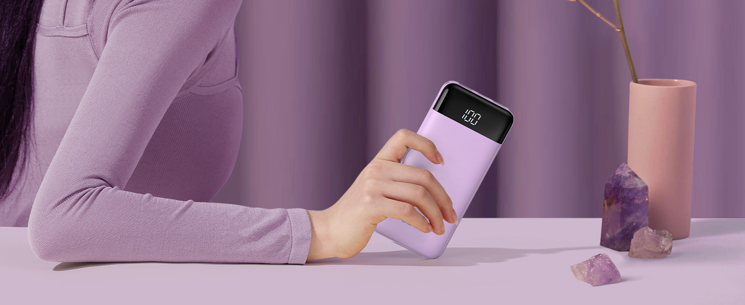 a woman holding a phone in her hand.