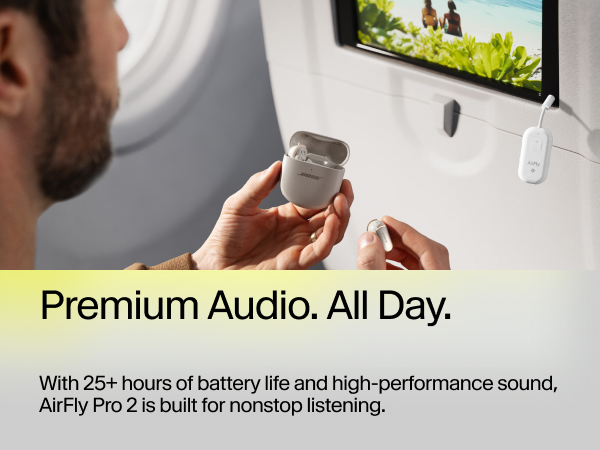 Man pairs Bose earbuds with AirFly Pro 2 on airplane to watch in-flight screen wirelessly.
