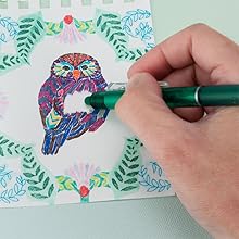 Photo shows person erasing colored pen from a drawing with the FriXion Clicker eraser